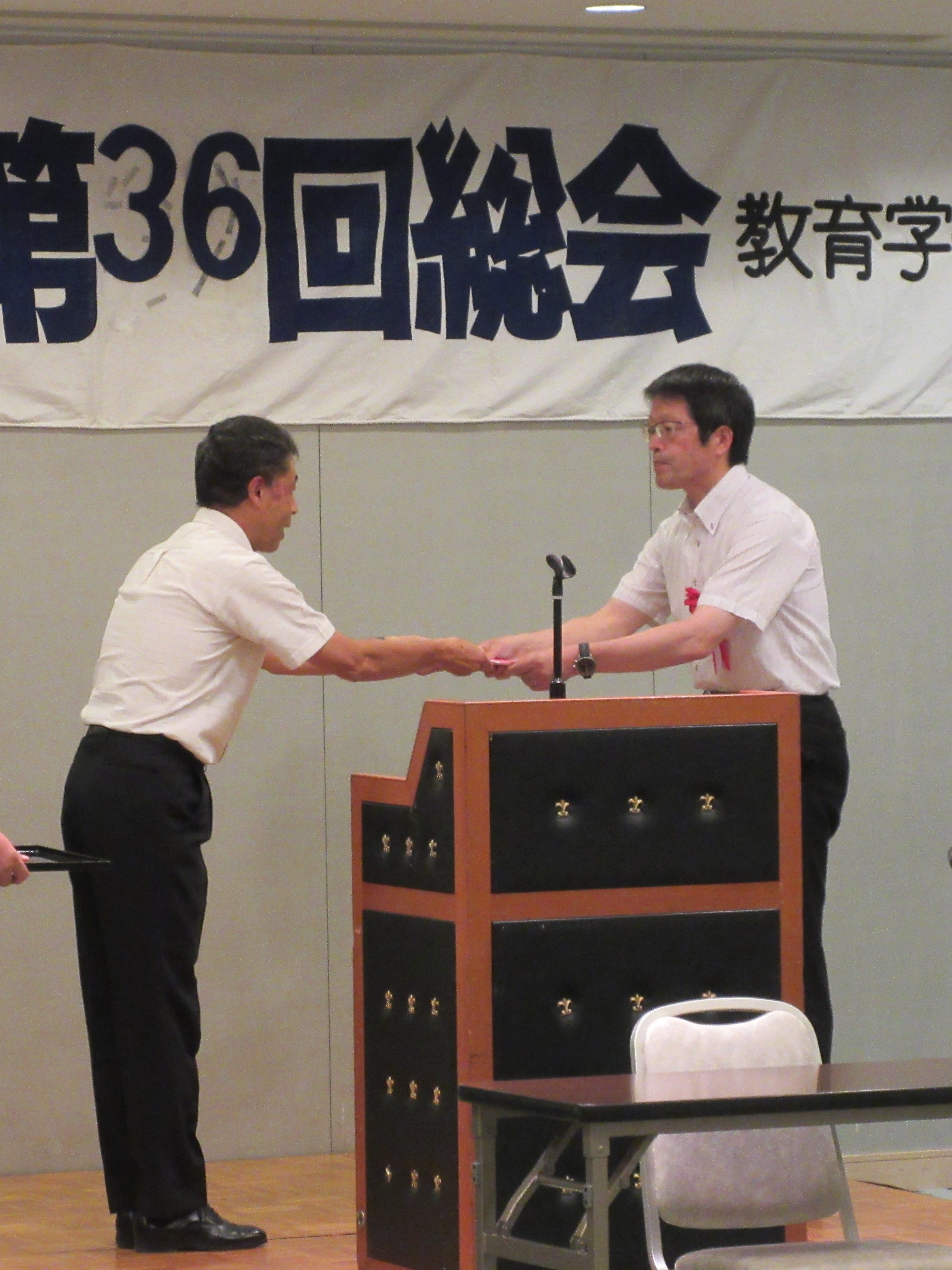 吉澤会長から村松学部長への贈呈